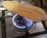 A picture of step 2 of Garma garam saikha hoa bhutta/ corn on the cob In stove flame.