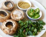 A picture of step 1 of Hummus stuffed cheesy mushrooms.