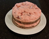 A picture of step 24 of Chocolate Layer Cake with Strawberry Cream Filling, White Chocolate Ganache Frosting coated with a Chocolate Crumble.