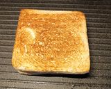 A picture of step 3 of Cheddar and brown sauce toastie.