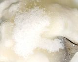 A picture of step 8 of Indian snack (crisp sphere with flavoured water/curd mixture).