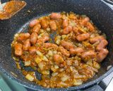 A picture of step 7 of Mini Pork Sausages with Red Pesto, Garlic, Onion, and Oregano.