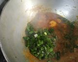 A picture of step 3 of Prawn curry with spring onion.