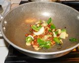 A picture of step 2 of Upma with puffed rice and colorful veggies.