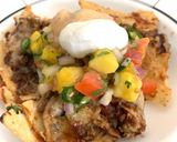A picture of step 11 of Loaded Nachos with Mango Salsa, Sour cream and cheese sauce.