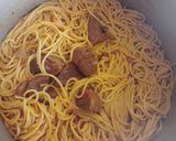 A picture of step 3 of Jollof spaghetti with beef and potato salad.