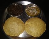 A picture of step 16 of Ashtami special prasaad the puri chana and halwa thali.