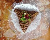 A picture of step 9 of Samsa with pastry sheets stuffed with almonds.