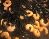 A picture of step 3 of Squid Ink Tagliolini with Grilled Shrimp, Mustard Pesto, and Toasted Pine Nuts.