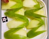 A picture of step 4 of Bunny- shaped green apple wedges.