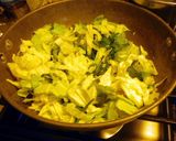 A picture of step 6 of Fried rice topped with green veggies.
