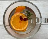 A picture of step 1 of Satsuma, rosemary and cranberry pick me up 🍊 🌿.
