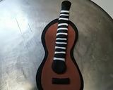 A picture of step 4 of Birthday cake music theme top on fondant guitar 🎸🎸🎸.