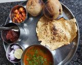 A picture of step 7 of Rajasthani dal bati with instant raw mango pickle.
