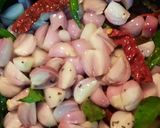 A picture of step 2 of Ulli theeyyal (shallots cooked in roasted coconut gravy and tamarind juice).