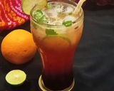 A picture of step 3 of Mulberry Orange Sunset layered Mocktail.
