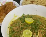 A picture of step 7 of Haleem with roti and jalebi.