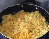 A picture of step 3 of Fried rice n plantain with chicken sauce garnished with kale leaf.