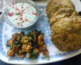 A picture of step 8 of Achari methi Puri with pethe ki sabzi and bathua raita.