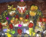 A picture of step 13 of Kunafa and Qashtalia Decorated with Oranges, Strawberries, and Bananas.