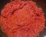 A picture of step 2 of Gajar Ka Halwa with milk and cashews.