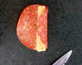 A picture of step 4 of My cheese wrapped in Pepperoni and Savoury Crackers 🤩.