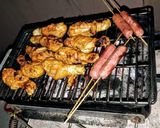 A picture of step 9 of Chicken paprika drums Skewered red hot Shrimps and grilled sausages.