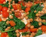 A picture of step 4 of Halloumi with pesto, balsamic tomatoes, spinach and chickpeas.