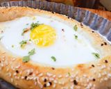 A picture of step 6 of Khachapuri with four cheese.