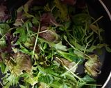 A picture of step 1 of Wilted greens with apples, raisins & nuts.