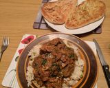 A picture of step 4 of Punjabi Lamb curry served with rice.