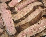 A picture of step 4 of Flank Steak on a bed of Onions.