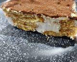 A picture of step 5 of Tiramisu with whipping cream.