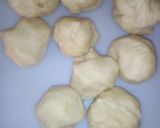 A picture of step 8 of Bow tie buns.