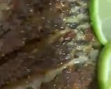 A picture of step 11 of Baked Tilapia Fish served with rocket leaves.
