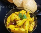A picture of step 9 of Kumaoni Aloo Gutke with pooris.