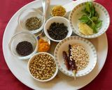 A picture of step 1 of Upma with puffed rice and colorful veggies.