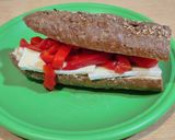 A picture of step 3 of Sandwich with 7-Grain Bread, Brie Cheese, Roasted Red Pepper Strips, and Hummus.