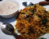 A picture of step 9 of Vegetable Dum Biryani with Onion,Tomato and cucumber Raita.