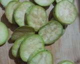 A picture of step 1 of Brinjal disk or baigan bhaja.