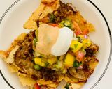 A picture of step 11 of Loaded Nachos with Mango Salsa, Sour cream and cheese sauce.