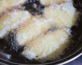 A picture of step 6 of Fried yam coated with egg and spicy fry sauce.