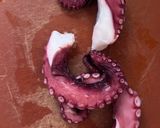 A picture of step 1 of Octopus Carpaccio in extra virgin oil oil and paprika powder.
