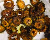 A picture of step 3 of Bitter melon chips in red onion.