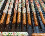 A picture of step 4 of Christmas chocolate covered pretzel rods.