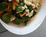 A picture of step 1 of Raw Mango carrot green chili garlic pickle.