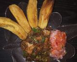 A picture of step 7 of Fried plantains,with beef stew and a side of kachumbari(salsa).