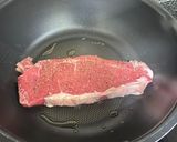 A picture of step 2 of Strip loin steak with simple side dish.