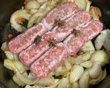 A picture of step 1 of Braised Pork Belly & Sausage.