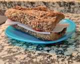 A picture of step 4 of Seven-Grain Bread Sandwich with Turkey Breast and Peppers.